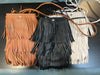 Sidesaddle Fringe Bag Ivory
-Ivory Faux Leather with 3 layers of fringe
--thin strap, cross body bag
- silver snap closure
- one compartment inside
- approximately 4.5' wide, 8" tall, no gusset
-usable interior space will be smaller due to snap closure
