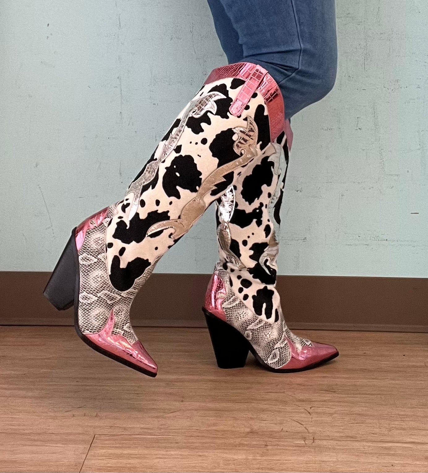 Pink Metallic Black White Multi Faux Cow Snake Zebra Cowboy Boot
- Knee High Colorblock Cowboy Boot
- Pointy Toe
- Cone Stacked Heel, Approx. 3