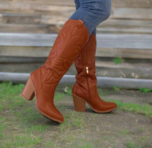 ARIZONA/2025
- Camel Tan Vegan Leather
- Knee High Cowboy Boot
- Western Styling with Stitching Detail
- Inner Half Zipper Closure
- Pointy Toe
- Cone Block Heel, Approx. 3"