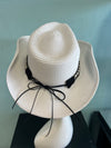 BUCKAROO straw hat natural white
-straw cowboy hat in natural white
-studded, braided, black and white band with silver bull
- moldable wire brim for customizable shape
-interior ribbon inside hat to customize size
This stylish straw cowboy hat in natural white is the perfect addition to your summer wardrobe. Not only is it adorned with a studded, braided black and white band featuring a striking silver bull, but it also boasts a moldable wire brim that allows you to create a unique and customiza