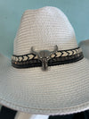 BUCKAROO straw hat natural white
-straw cowboy hat in natural white
-studded, braided, black and white band with silver bull
- moldable wire brim for customizable shape
-interior ribbon inside hat to customize size
This stylish straw cowboy hat in natural white is the perfect addition to your summer wardrobe. Not only is it adorned with a studded, braided black and white band featuring a striking silver bull, but it also boasts a moldable wire brim that allows you to create a unique and customiza