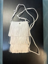 Sidesaddle Fringe Bag Ivory
-Ivory Faux Leather with 3 layers of fringe
--thin strap, cross body bag
- silver snap closure
- one compartment inside
- approximately 4.5' wide, 8" tall, no gusset
-usable interior space will be smaller due to snap closure