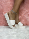 ROOKIE-16
- White Faux Leather
- Slip-On Slide
- Open Toe
- Platform Sole, Approx. 3”