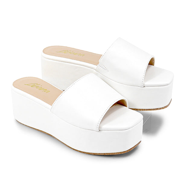 ROOKIE-16
- White Faux Leather
- Slip-On Slide
- Open Toe
- Platform Sole, Approx. 3”