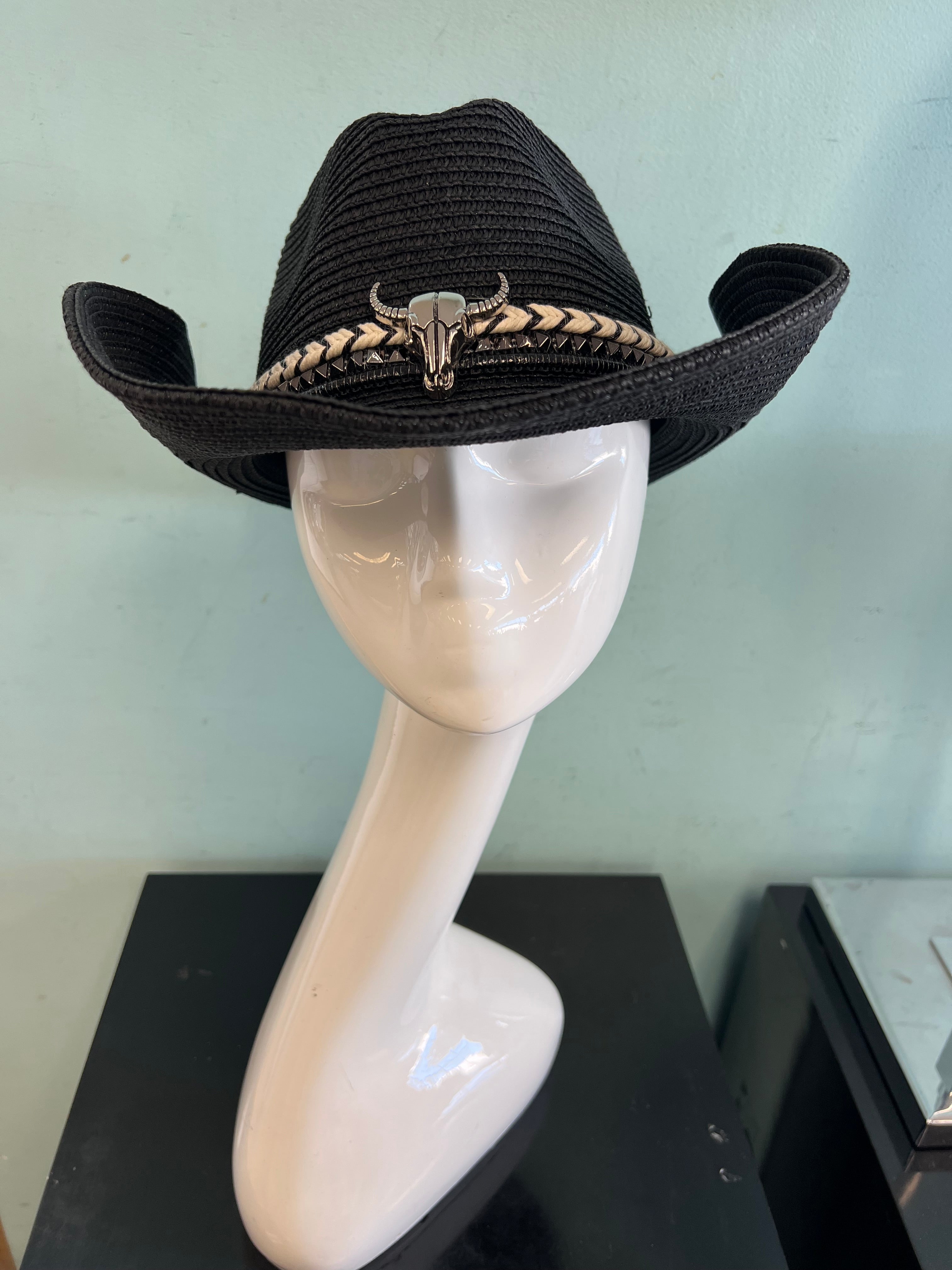 buckaroo straw black cowboy hat
-straw cowboy hat in black
-studded, braided, black and white band with silver bull
- moldable wire brim for customizable shape
-interior ribbon inside hat to customize size