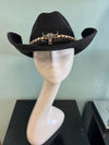 buckaroo straw black cowboy hat
-straw cowboy hat in black
-studded, braided, black and white band with silver bull
- moldable wire brim for customizable shape
-interior ribbon inside hat to customize size