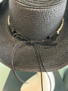 buckaroo straw black cowboy hat
-straw cowboy hat in black
-studded, braided, black and white band with silver bull
- moldable wire brim for customizable shape
-interior ribbon inside hat to customize size
