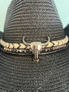 buckaroo straw black cowboy hat
-straw cowboy hat in black
-studded, braided, black and white band with silver bull
- moldable wire brim for customizable shape
-interior ribbon inside hat to customize size