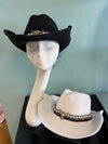 buckaroo straw black cowboy hat
-straw cowboy hat in black
-studded, braided, black and white band with silver bull
- moldable wire brim for customizable shape
-interior ribbon inside hat to customize size