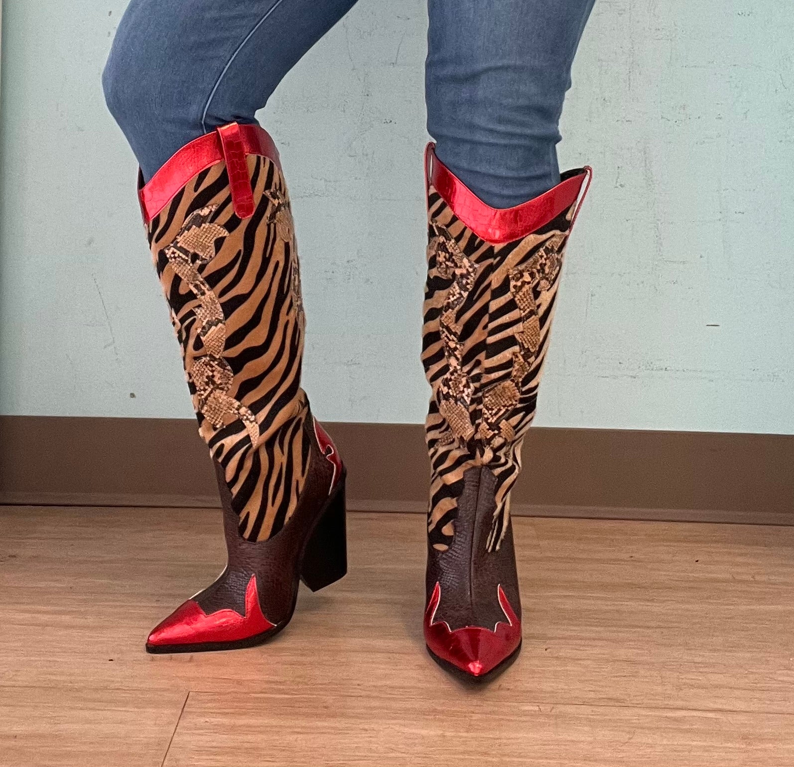 Red Metallic Black Brown Multi Faux Tiger Snake Cowboy Boot
- Knee High Colorblock Cowboy Boot
- Pointy Toe
- Cone Stacked Heel, Approx. 3