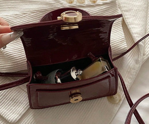MORGAN BURGUNDY PATENT LEATHER CROSS BODY BAG WITH GOLD BUCKLE DETAIL