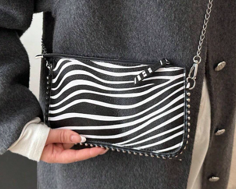 TARA ZEBRA FAUX LEATHER RECTANGULAR CLUTCH WITH SILVER STUDDED BORDER AND REMOVEABLE CHAIN STRAP