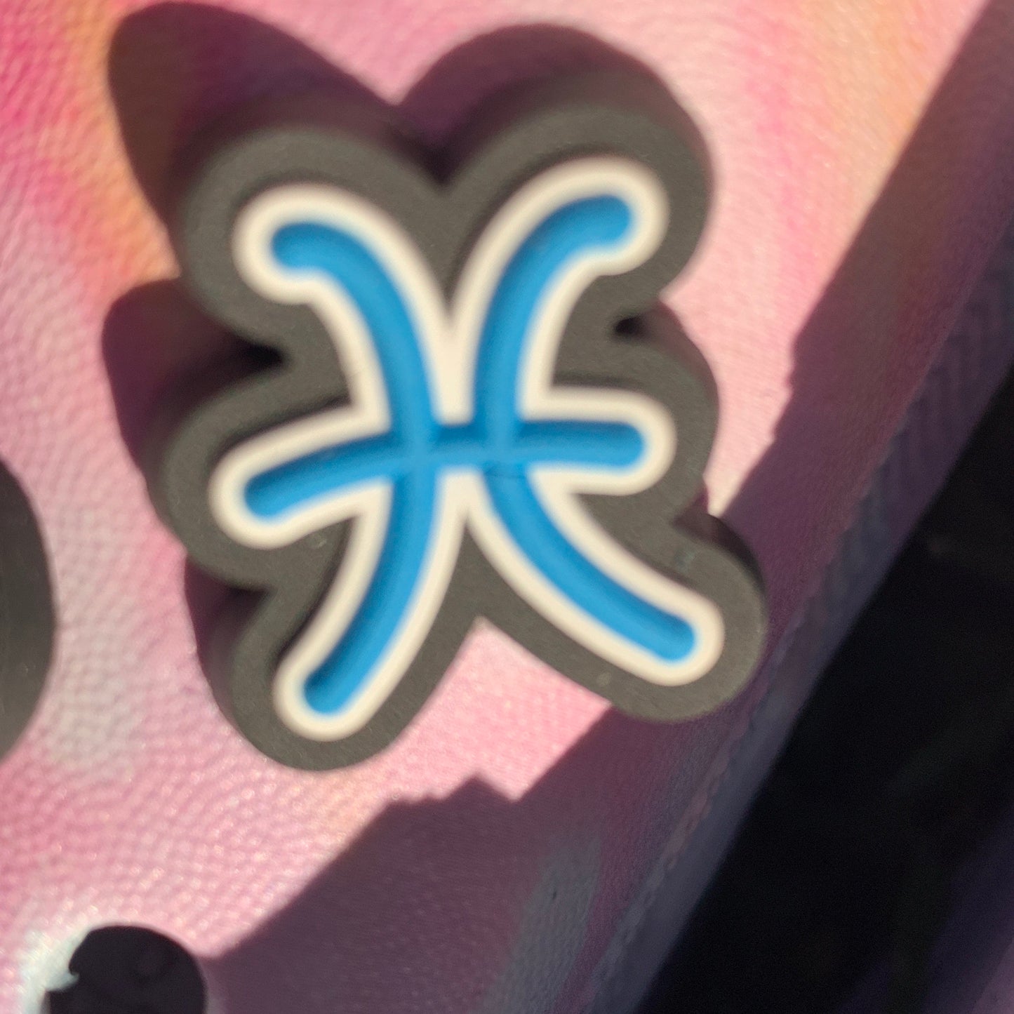 a close up of a pair of scissors on a pink box