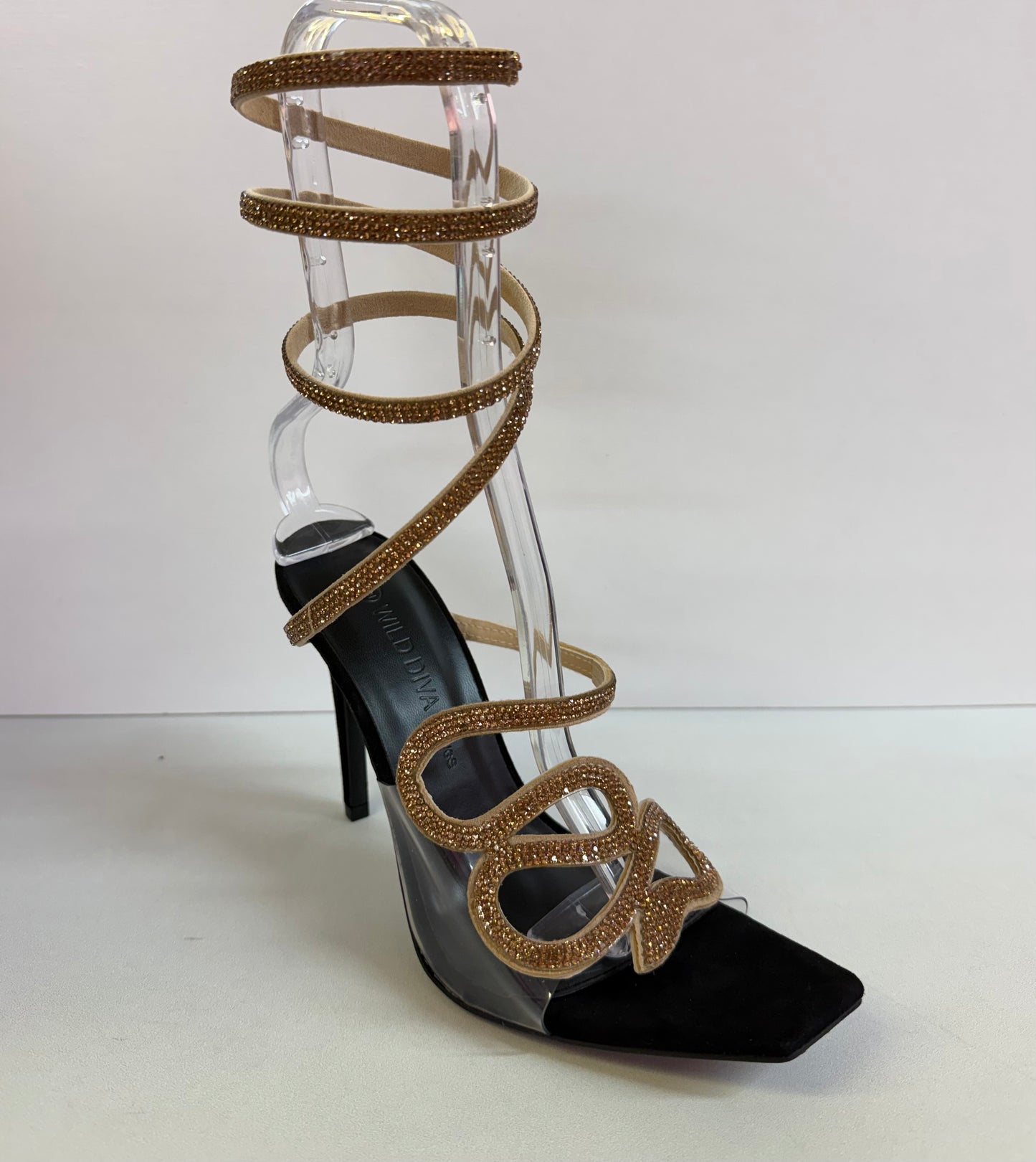 LACEY-35 BLACK STILETTO HEEL WITH GOLD RHINESTONE ASSYMETRICAL SERPENT DESIGN ON CLEAR VAMP AND SPIRAL ANKLE STRAP