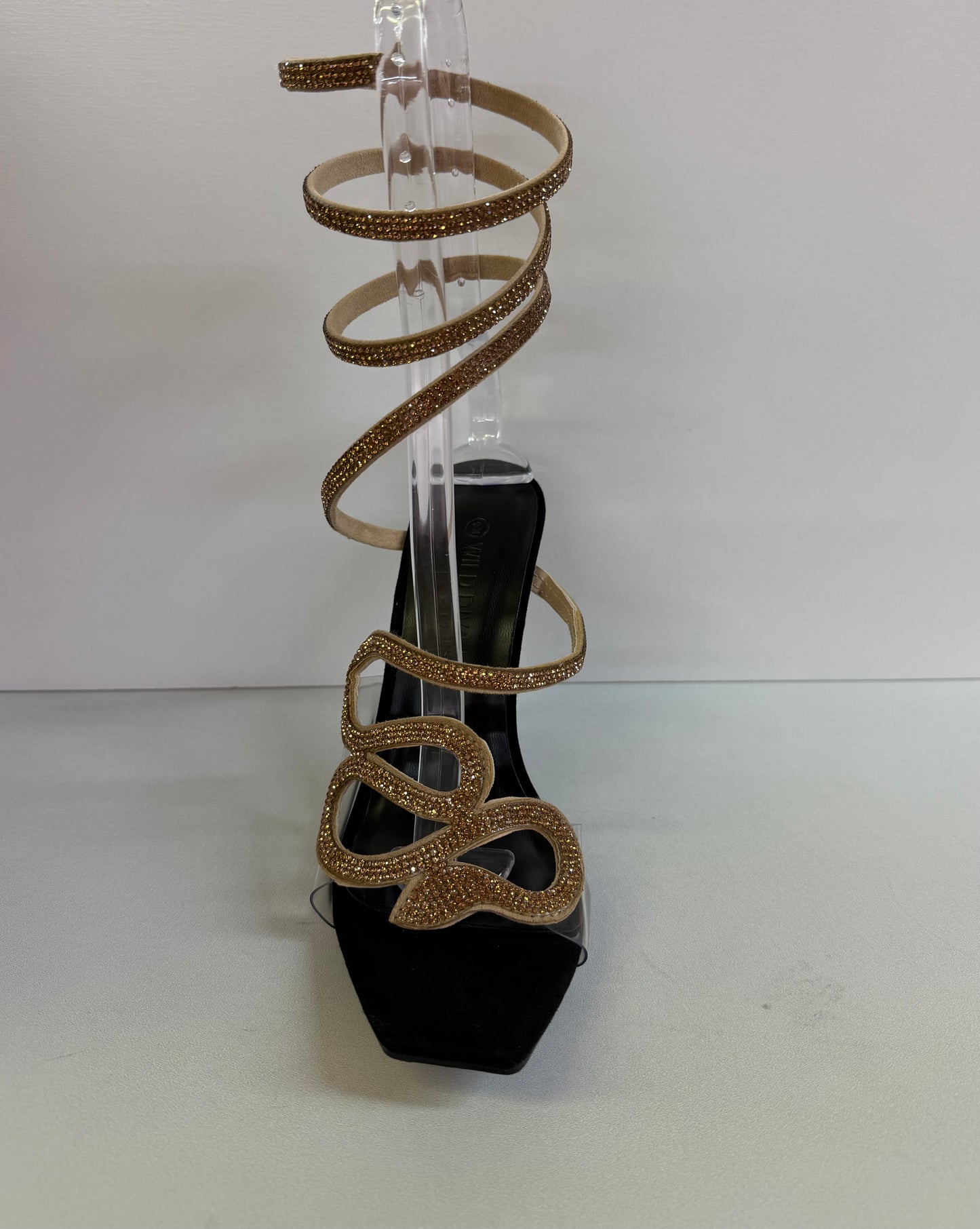 LACEY-35 BLACK STILETTO HEEL WITH GOLD RHINESTONE ASSYMETRICAL SERPENT DESIGN ON CLEAR VAMP AND SPIRAL ANKLE STRAP