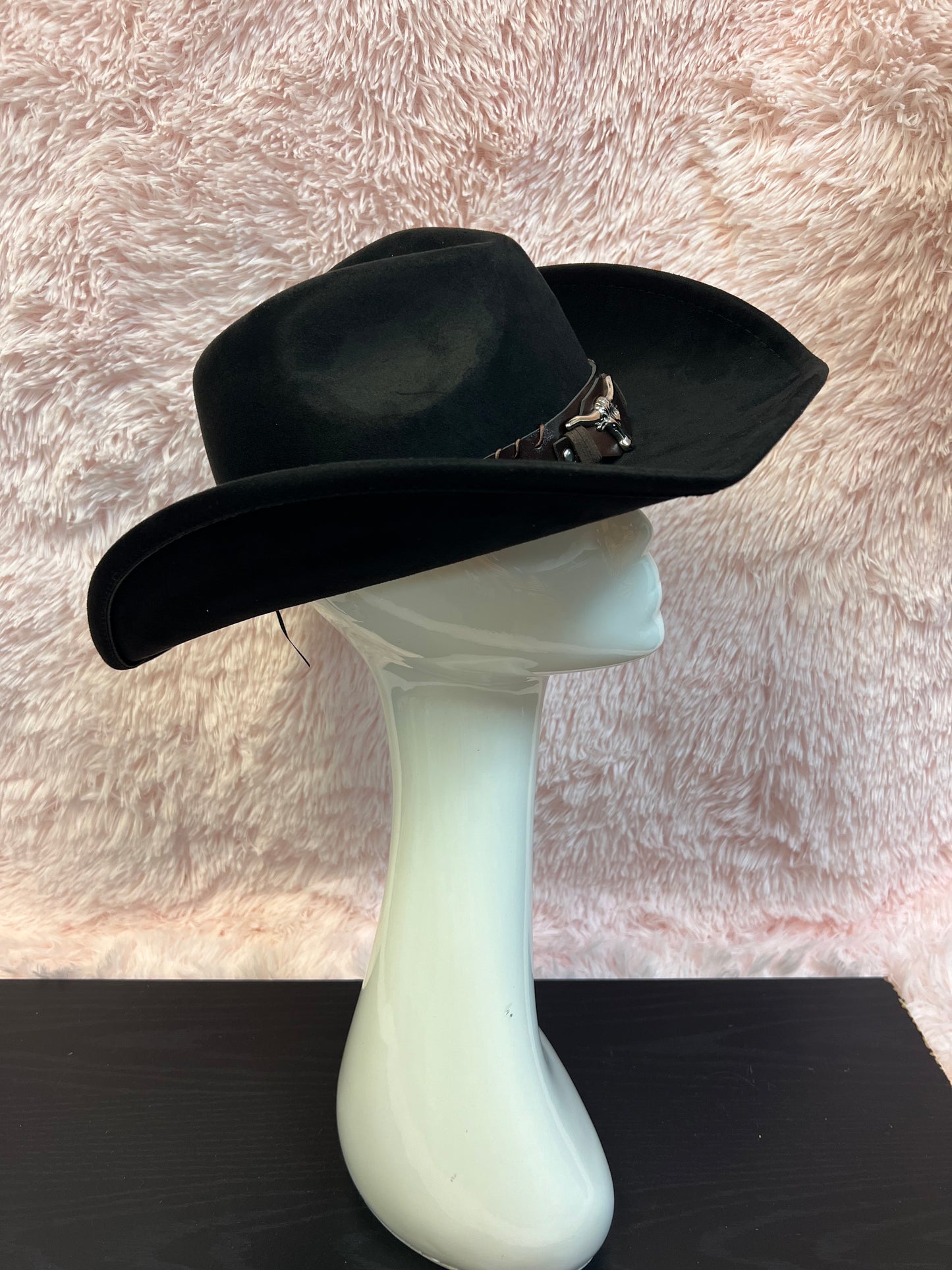 -faux suede cowboy hat in black

-brown faux leather band with silver studs and bull detail

-interior ribbon inside hat to customize size

-stiff, sturdy structure