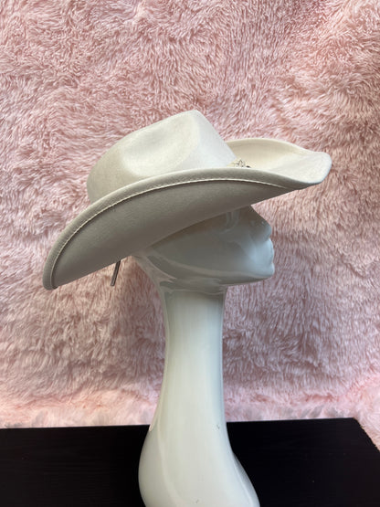 -faux suede cowboy hat in ivory

-all ivory faux leather band with braided and silver studded detail

-interior ribbon inside hat to customize size

-stiff, sturdy structure