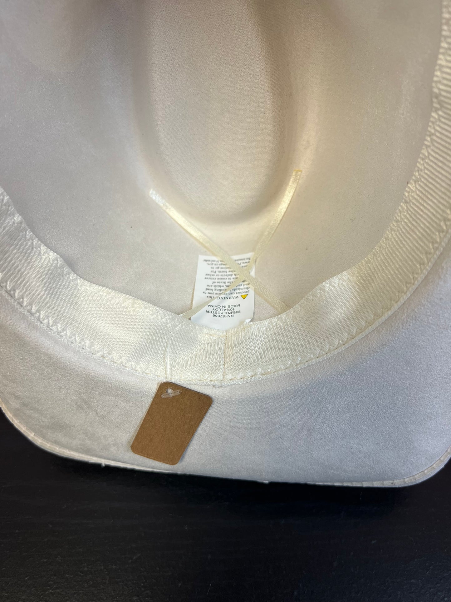 -faux suede cowboy hat in ivory

-all ivory faux leather band with braided and silver studded detail

-interior ribbon inside hat to customize size

-stiff, sturdy structure
