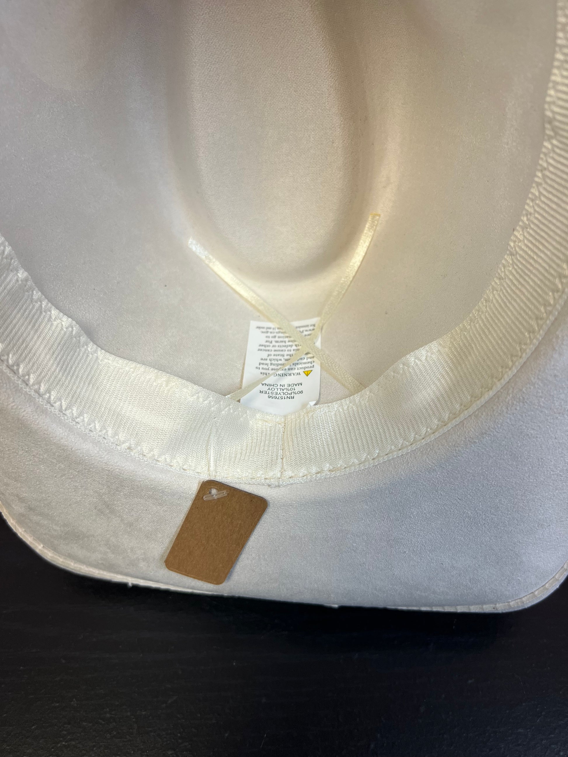 -faux suede cowboy hat in ivory

-all ivory faux leather band with braided and silver studded detail

-interior ribbon inside hat to customize size

-stiff, sturdy structure