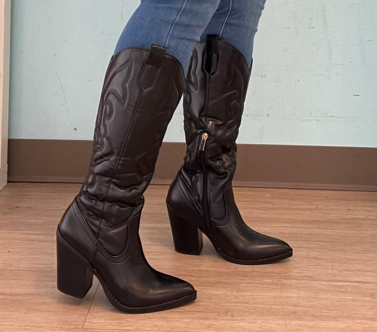 ARIZONA/2025

- Black Vegan Leather
- Knee High Cowboy Boot
- Western Styling with Stitching Detail
- Inner Half Zipper Closure
- Pointy Toe
- Cone Block Heel, Approx. 3"