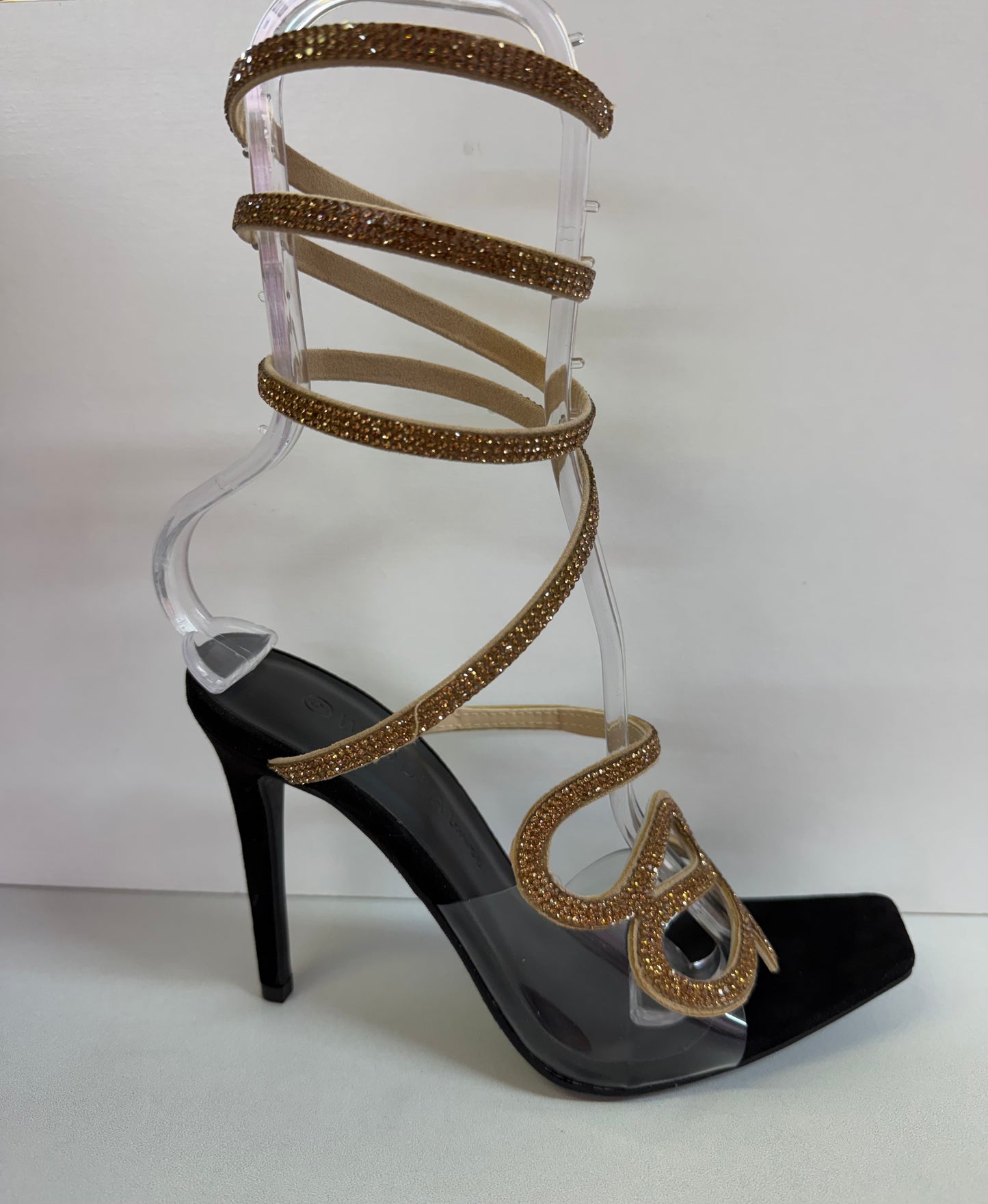 LACEY-35 BLACK STILETTO HEEL WITH GOLD RHINESTONE ASSYMETRICAL SERPENT DESIGN ON CLEAR VAMP AND SPIRAL ANKLE STRAP