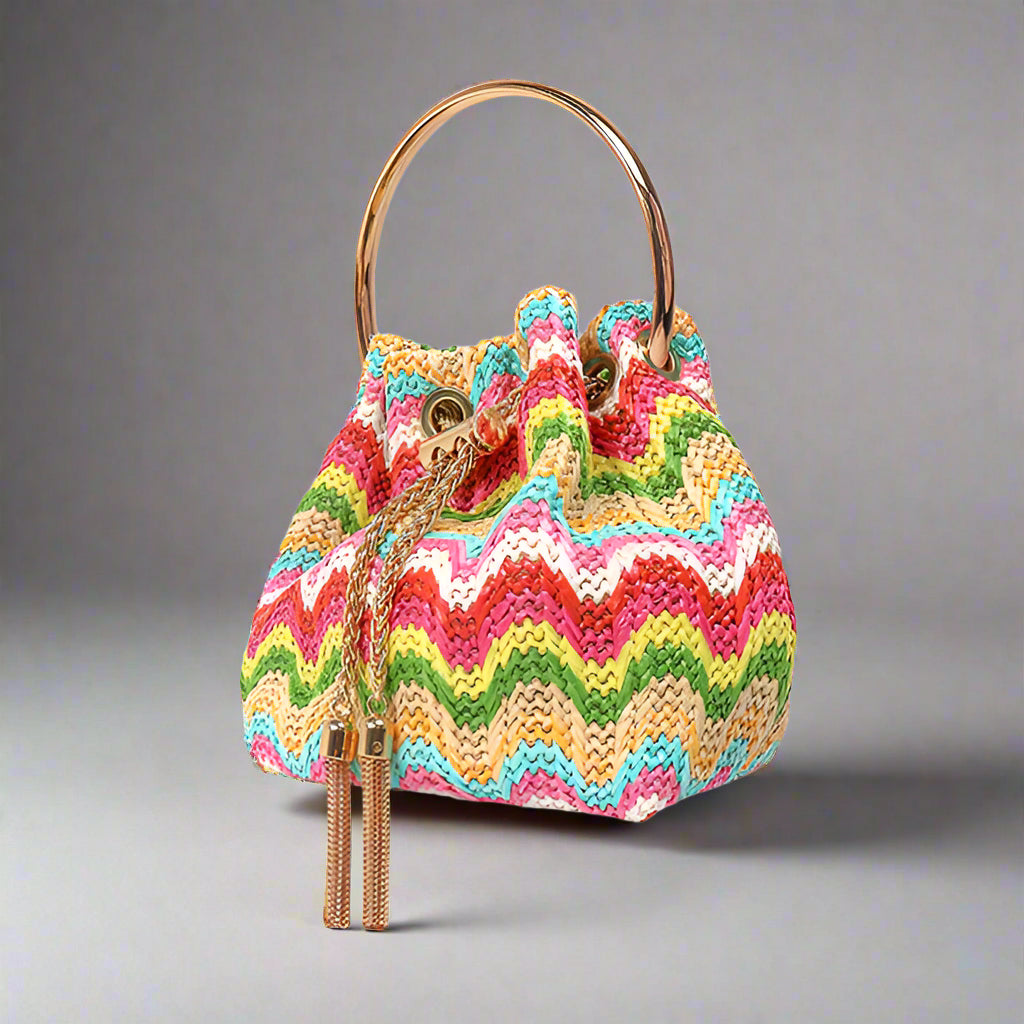 RAFFINO BAG

- Multicolor Striped Raffia Handbag
- Cinched Drawstring Closure with Gold Chain and Tassel Accents
- Gold Circle Handle&nbsp;