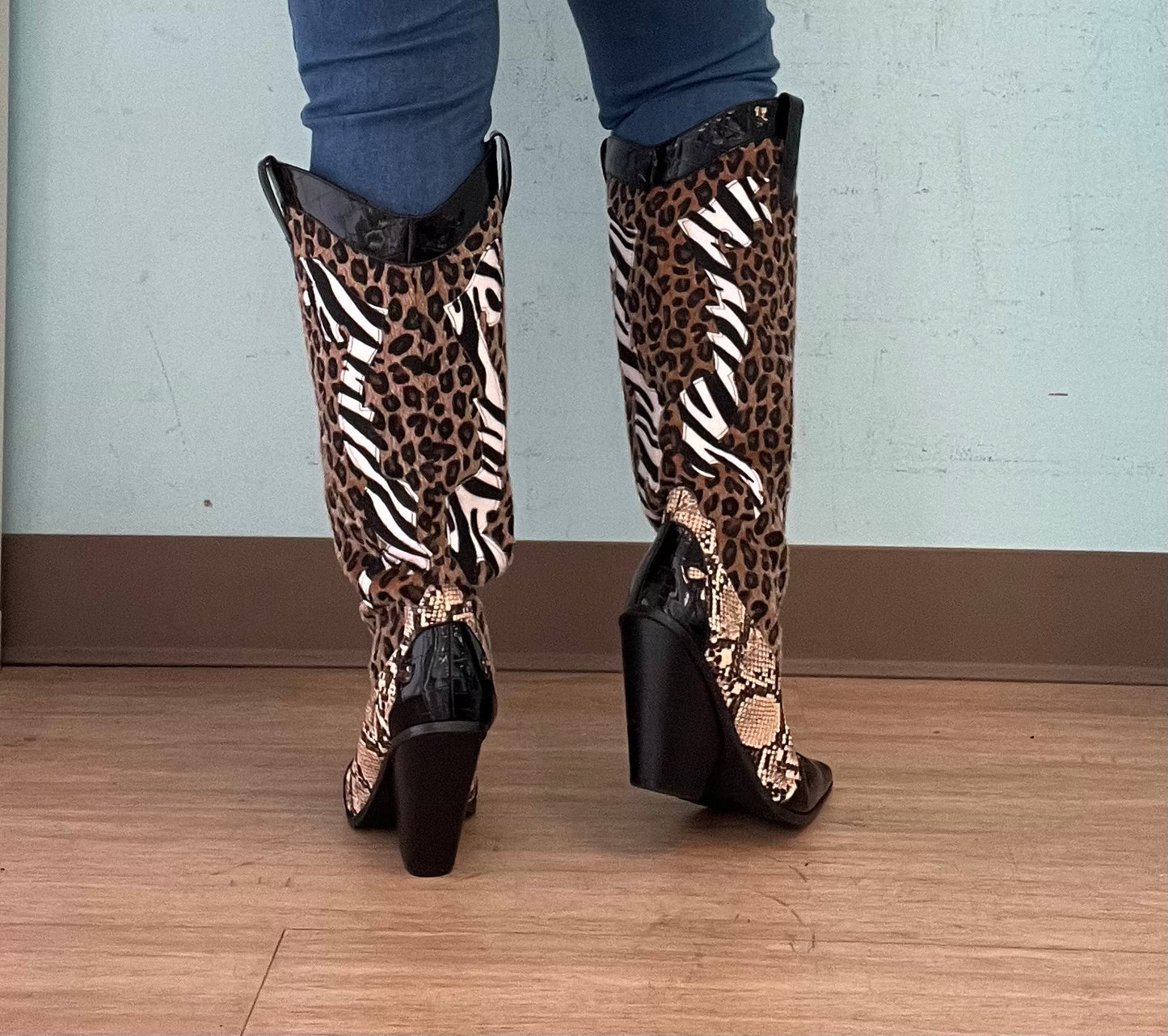 Karine Black Brown Multi Faux Leopard Snake Zebra Cowboy Boot
- Knee High Colorblock Cowboy Boot
- Pointy Toe
- Cone Stacked Heel, Approx. 3"