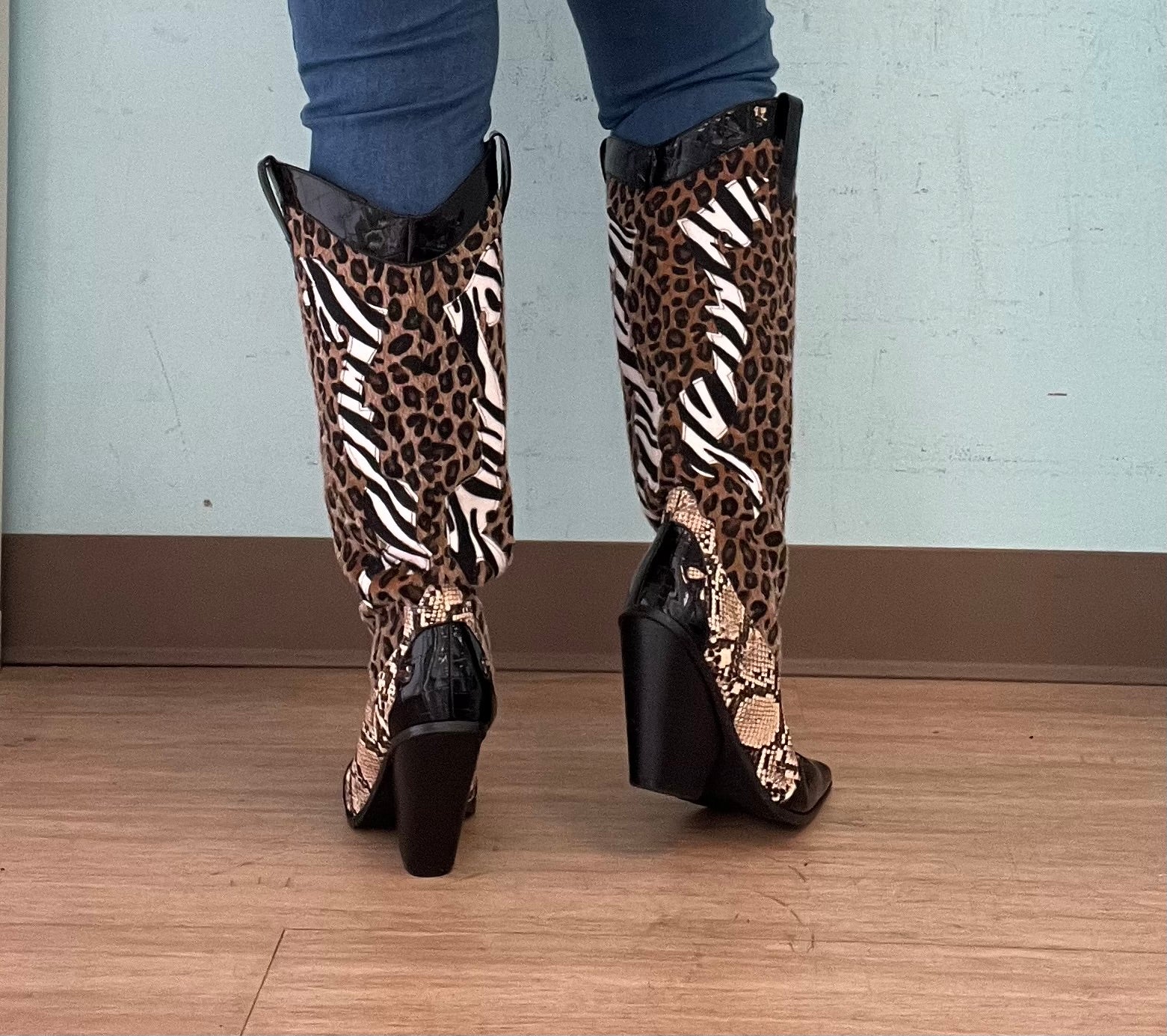 Karine Black Brown Multi Faux Leopard Snake Zebra Cowboy Boot
- Knee High Colorblock Cowboy Boot
- Pointy Toe
- Cone Stacked Heel, Approx. 3"