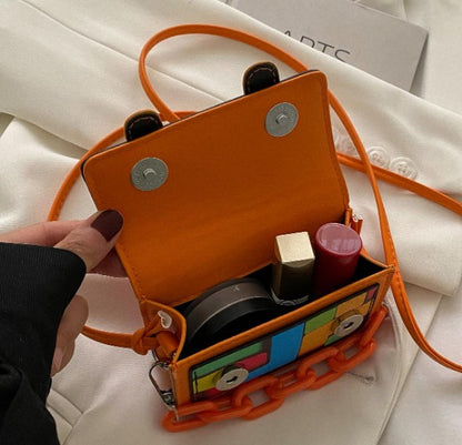 TRINA ORANGE PRINTED MINI BAG WITH CROSS BODY STRAP