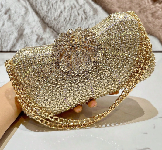KAMILA GOLD RHINESTONE COVERED HARD CASE CLUTCH EVENING BAG WITH LARGE RHINESTONE FLOWER CLASP AND  SHORT DOUBLE CHAIN STRAPS