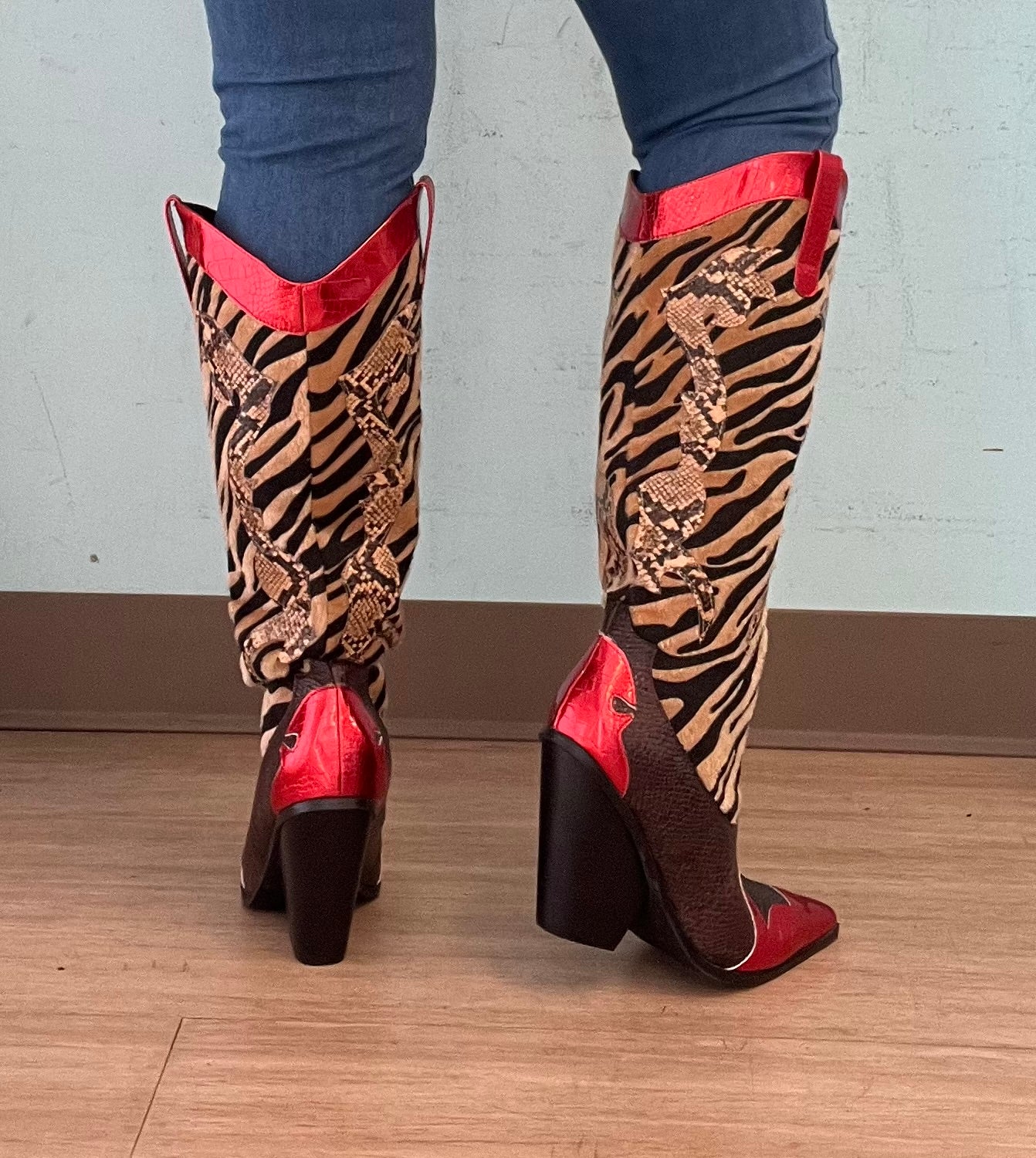 Red Metallic Black Brown Multi Faux Tiger Snake Cowboy Boot
- Knee High Colorblock Cowboy Boot
- Pointy Toe
- Cone Stacked Heel, Approx. 3"