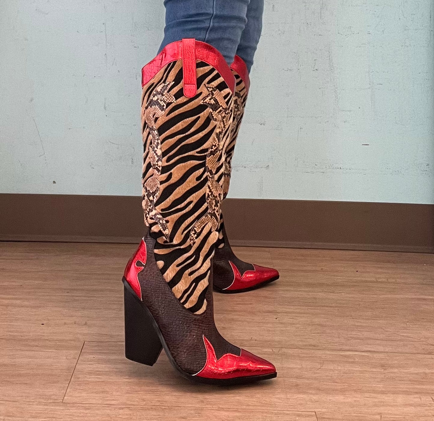 Red Metallic Black Brown Multi Faux Tiger Snake Cowboy Boot
- Knee High Colorblock Cowboy Boot
- Pointy Toe
- Cone Stacked Heel, Approx. 3"