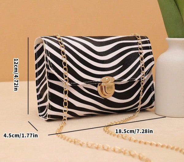 LYRA ZEBRA BLACK AND WHITE BAG WITH GOLD CLASP AND CROSS BODY STRAP
