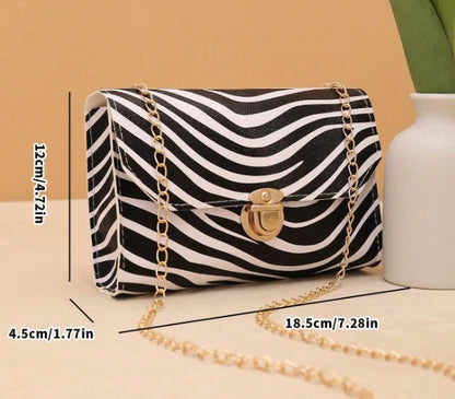 LYRA ZEBRA BLACK AND WHITE BAG WITH GOLD CLASP AND CROSS BODY STRAP