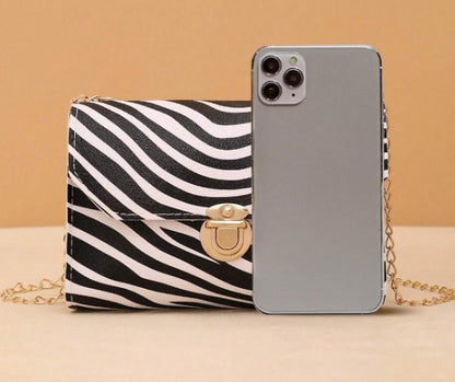 LYRA ZEBRA BLACK AND WHITE BAG WITH GOLD CLASP AND CROSS BODY STRAP