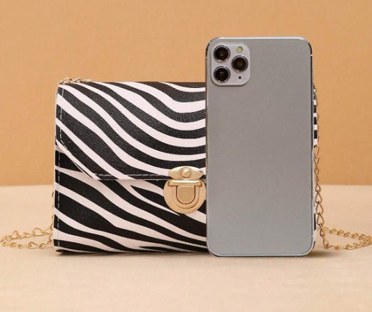 LYRA ZEBRA BLACK AND WHITE BAG WITH GOLD CLASP AND CROSS BODY STRAP