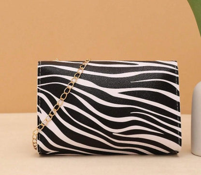 LYRA ZEBRA BLACK AND WHITE BAG WITH GOLD CLASP AND CROSS BODY STRAP