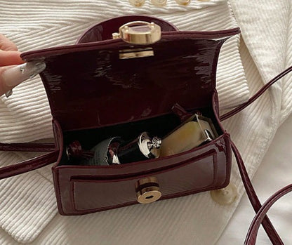 MORGAN BURGUNDY PATENT LEATHER CROSS BODY BAG WITH GOLD BUCKLE DETAIL