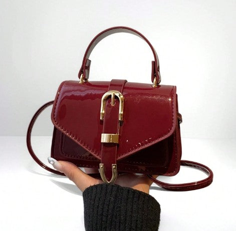 MORGAN BURGUNDY PATENT LEATHER CROSS BODY BAG WITH GOLD BUCKLE DETAIL
