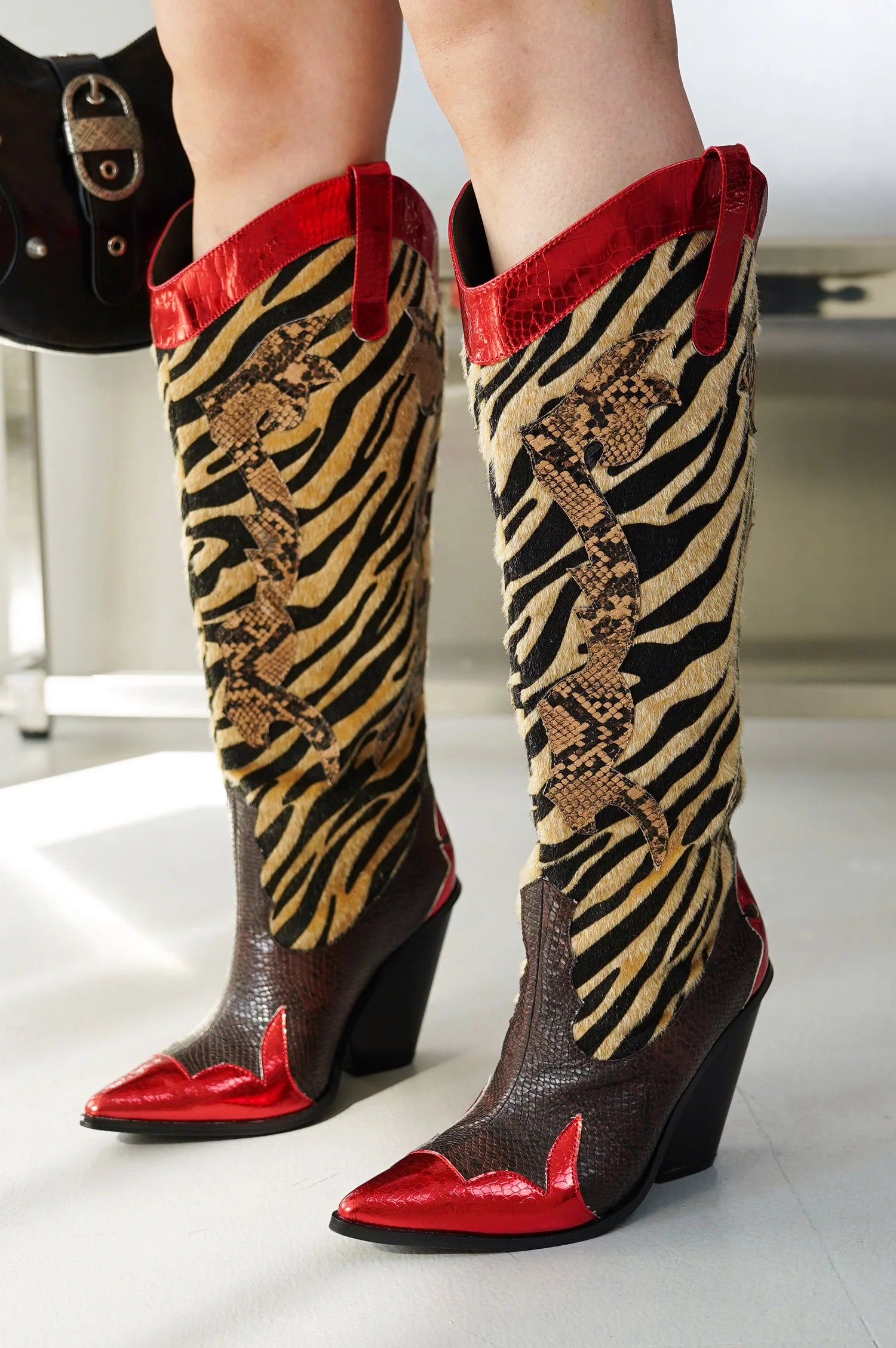 Red Metallic Black Brown Multi Faux Tiger Snake Cowboy Boot
- Knee High Colorblock Cowboy Boot
- Pointy Toe
- Cone Stacked Heel, Approx. 3"