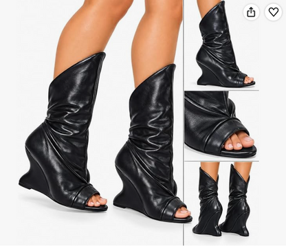 PACO-3 BLACK FAUX LEATHER  PEEP TOE BOOT WITH ASSYMETRICAL SHAFT AND SCULPTED CUT OUT WEDGE HEEL