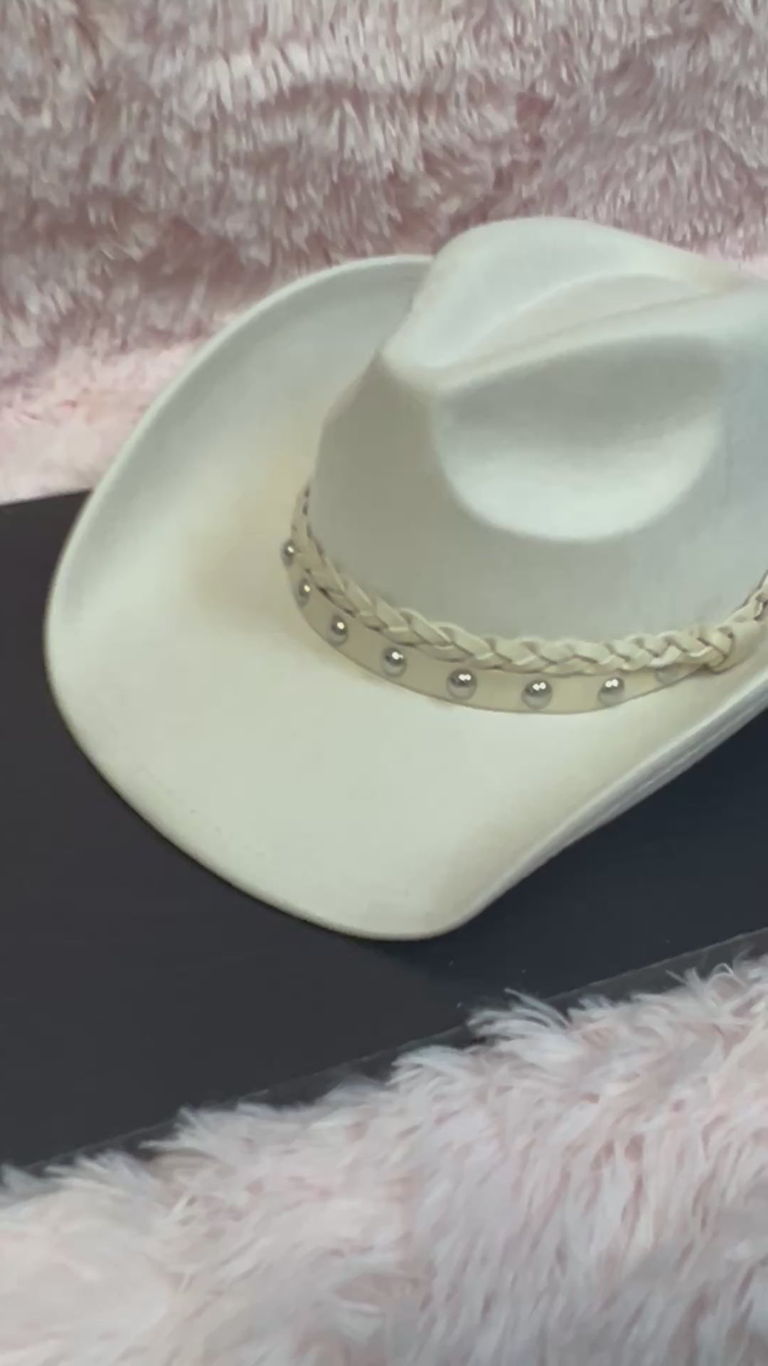 -faux suede cowboy hat in ivory

-all ivory faux leather band with braided and silver studded detail

-interior ribbon inside hat to customize size

-stiff, sturdy structure