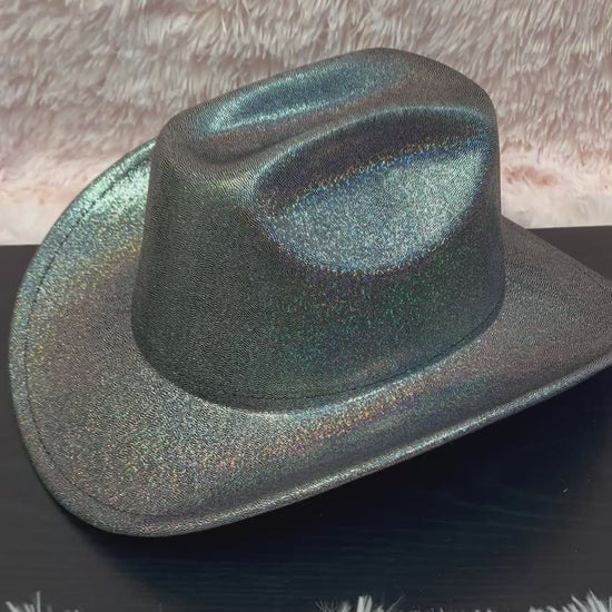 -cowboy hat with black base and iridescent glitter&nbsp;

-glittery poly fabric&nbsp;

-interior ribbon inside hat to customize size

-stiff, sturdy structure