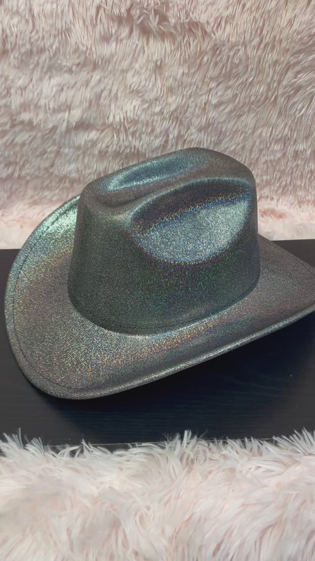-cowboy hat with black base and iridescent glitter&nbsp;

-glittery poly fabric&nbsp;

-interior ribbon inside hat to customize size

-stiff, sturdy structure