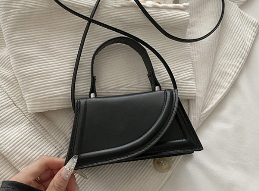 SONDRA BLACK FAUX LEATHER MINIBAG WITH ASYMMETRICAL FOLD DESIGN SMALL HANDLE AND OPTIONAL CROSSBODY STRAP