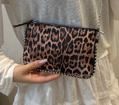 TARA LEOPARD FAUX LEATHER RECTANGULAR CLUTCH WITH SILVER STUDDED BORDER AND REMOVEABLE CHAIN STRAP