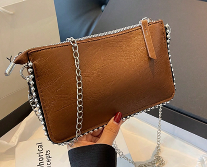 TARA BROWN FAUX LEATHER RECTANGULAR CLUTCH WITH SILVER STUDDED BORDER AND REMOVEABLE CHAIN STRAP