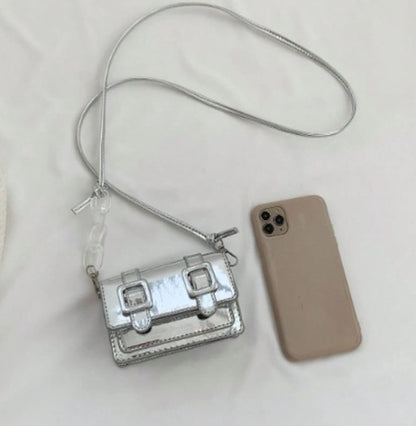 TRINA SILVER MINI BAG WITH DOUBLE BUCKLE DESIGN AND CROSS BODY STRAP