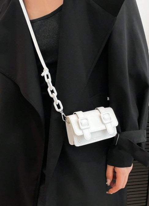 TRINA WHITE MINI BAG WITH DOUBLE BUCKLE DESIGN AND CROSS BODY STRAP