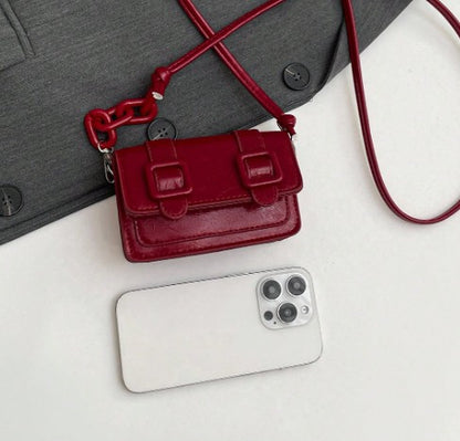 TRINA WINE MINI BAG WITH DOUBLE BUCKLE DESIGN AND CROSS BODY STRAP